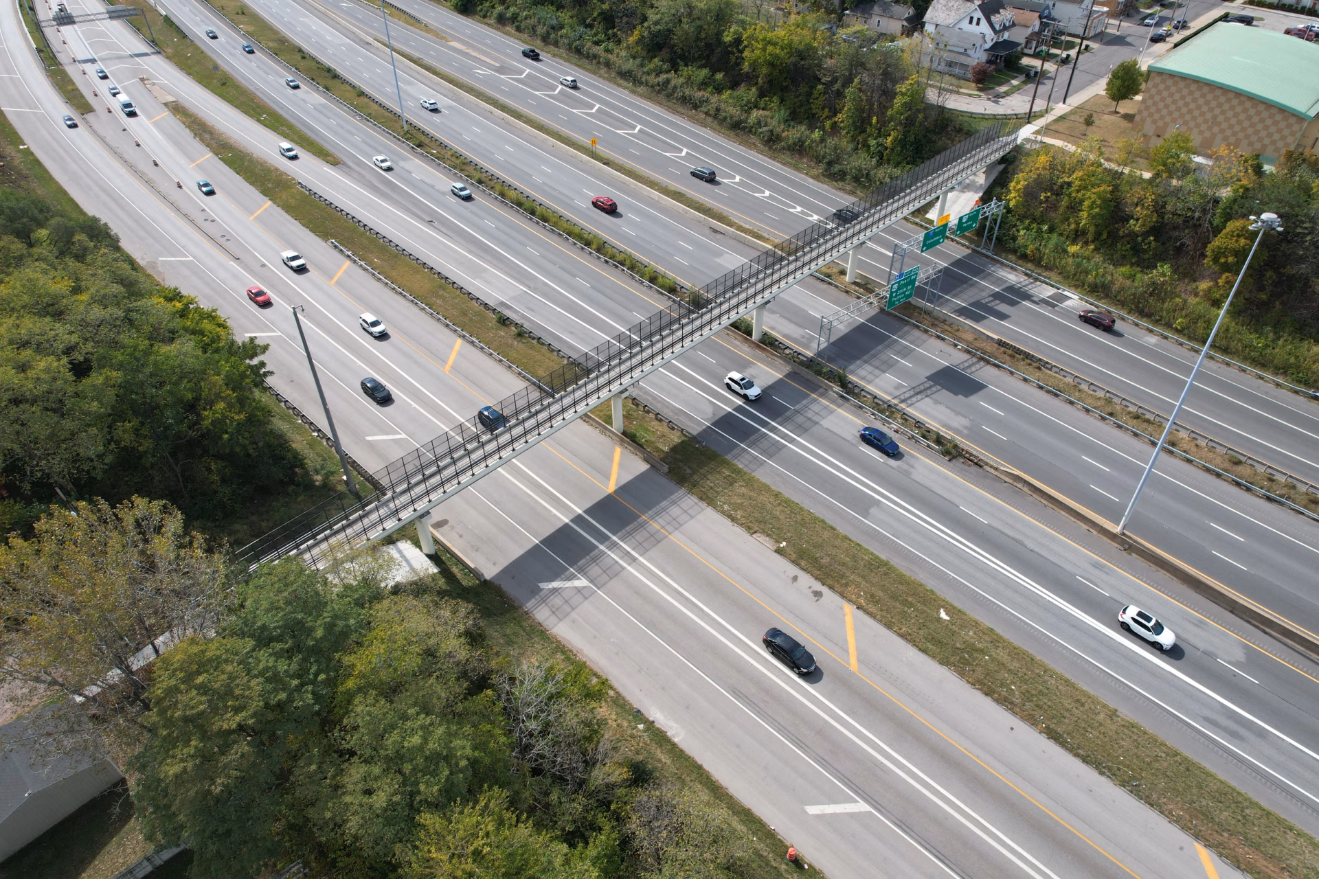 Aerial view of a pedestrian bridge crossing a divided highway